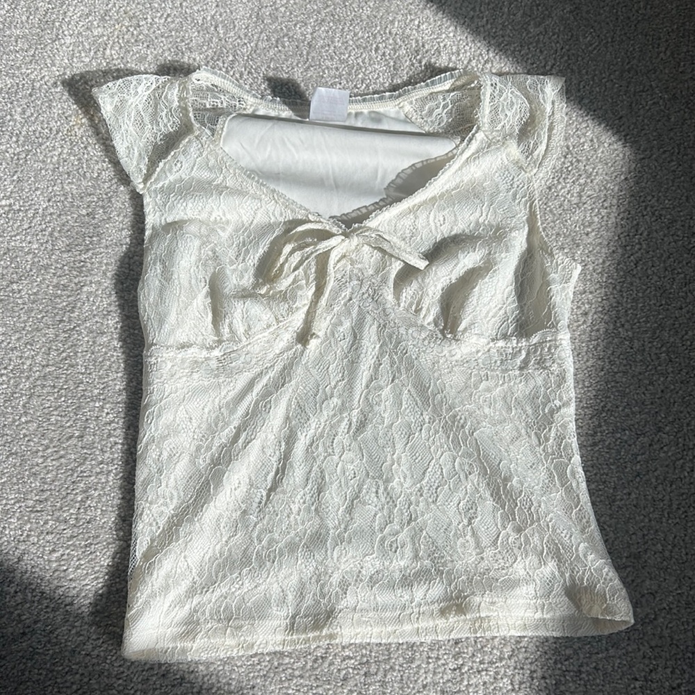 Creamy white lace top with bow detail